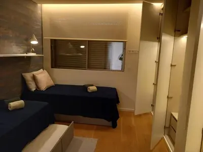 a small room with two beds and a window at Prestige & Nature Apartment in Laguna Village in Quarteira