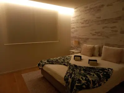 a bedroom with a bed with two books on it at Prestige & Nature Apartment in Laguna Village in Quarteira