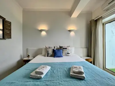 a bedroom with a bed with two towels on it at Albufeira Stylish 1 by Homing in Albufeira