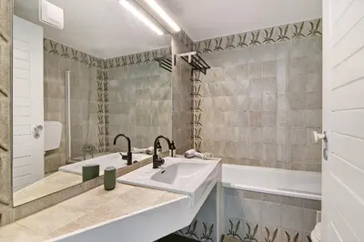 a bathroom with a white sink and a tub at Ocean View Apartment Hakuna Matata in Albufeira