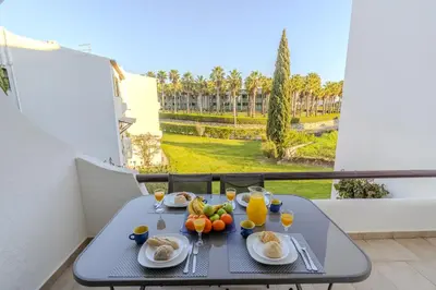 a table with a bowl of fruit on top of it at #082 Families Only - São Rafael by Home Holidays in Albufeira