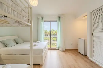 a bedroom with two beds and a balcony at #082 Families Only - São Rafael by Home Holidays in Albufeira