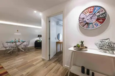 a living room with a clock on the wall at Downtown Albufeira 3-Bedroom Luxury Apartment in Albufeira