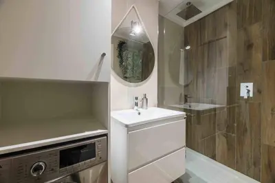 a white bathroom with a sink and a shower at Downtown Albufeira 3-Bedroom Luxury Apartment in Albufeira