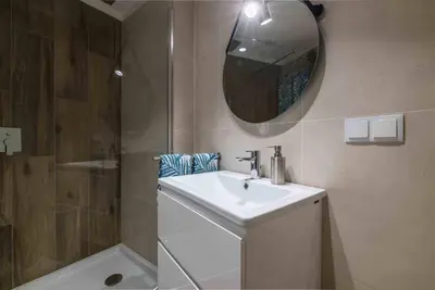 a bathroom with a sink and a shower and a mirror at Downtown Albufeira 3-Bedroom Luxury Apartment in Albufeira