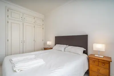 a bedroom with a white bed with two white towels on it at Vilamoura City Centre Flat in Vilamoura