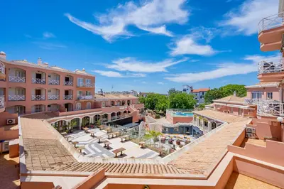 an aerial view of a building with a pool at Vilamoura City Centre Flat in Vilamoura