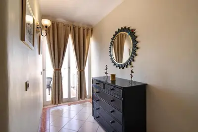 a room with a dresser and a mirror on the wall at Paradis Bleu in Albufeira