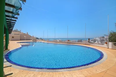 a large blue swimming pool on top of a building at Paradis Bleu in Albufeira