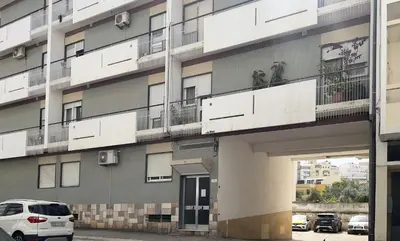 an apartment building with two monkeys on the balcony at Casa AL Reis in Faro