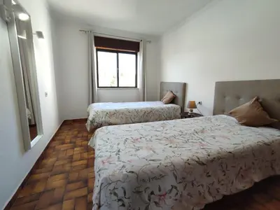 a bedroom with two beds and a window at Apartamento V2 Pedro - By Bedzy in Albufeira