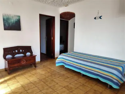 a bedroom with a bed and a wooden table at Apartamento V2 Pedro - By Bedzy in Albufeira