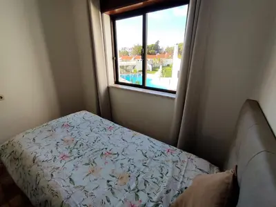 a small bedroom with a bed and a window at Apartamento V2 Pedro - By Bedzy in Albufeira