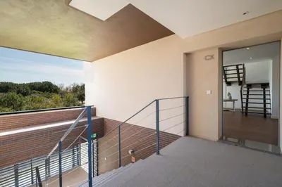 a balcony of a house with a glass door at Apart L'Orange in Vilamoura