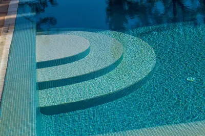 a swimming pool with stairs in the water at Cypress Villa in Albufeira