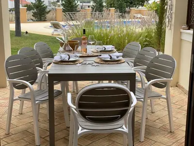 a table and chairs with food and drinks on it at Villa Cascata, 3 bedroom, Pool, close to Olhos de Agua in Albufeira