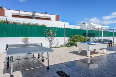 a ping pong table sitting on top of a patio at Villa Alfazema in Albufeira