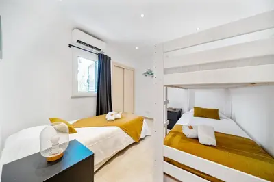 a bedroom with two beds and a bunk bed at Villa at the beach in Vale do Lobo