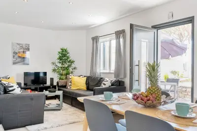 a living room with a table with a bowl of fruit on it at Villa at the beach in Vale do Lobo