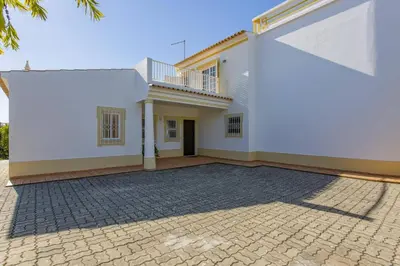 a large white house with a brick driveway at Villa Colina do Sol by Villa Plus in Paderne