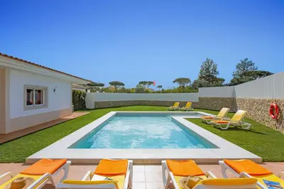 a kitchen and dining room with a table and chairs at Villa Quinta dos Abacates by Villa Plus in Olhos de Água