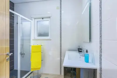 a bathroom with a sink and a shower at Villa Quinta dos Abacates by Villa Plus in Olhos de Água