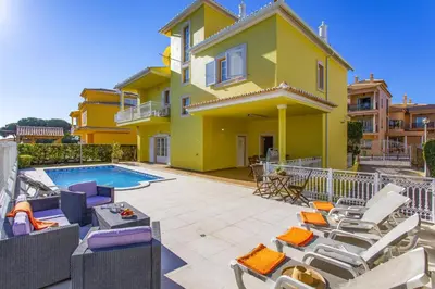 a villa with a swimming pool and patio furniture at Villa Quinta dos Bicos by Villa Plus in Albufeira
