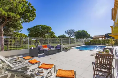 a patio with furniture and a swimming pool at Villa Quinta dos Bicos by Villa Plus in Albufeira