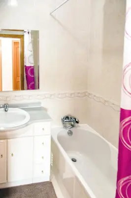 a bathroom with a bath tub and a sink at Tatiana 1 bedroom apartment in Albufeira