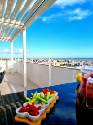 a tray of vegetables on a table on a balcony at Penthouse Rentalbufeira in Albufeira