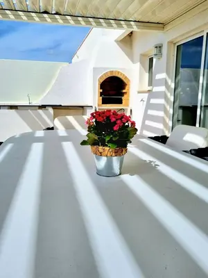 a pot of flowers sitting on a porch at Penthouse Rentalbufeira in Albufeira