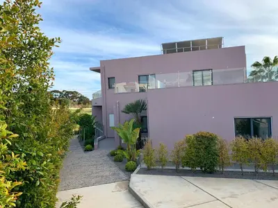 a pink house with plants in front of it at DIANA BEACH HOUSE in Albufeira
