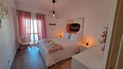 a bedroom with a bed with two candles on it at Albufeira Oura Beach Apartment in Albufeira