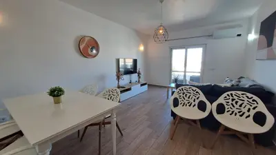 a living room with a couch and a table at Albufeira Oura Beach Apartment in Albufeira