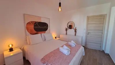 a bedroom with a bed with two towels on it at Albufeira Oura Beach Apartment in Albufeira