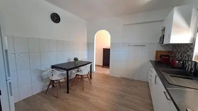 a kitchen with a table and chairs in a room at Albufeira Oura Beach Apartment in Albufeira