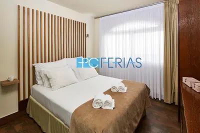 a hotel room with a bed with two towels on it at Apartamento em Albufeira a 10 min da praia * 50070/AL in Albufeira