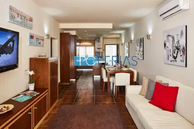 a living room with a couch and a dining room at Apartamento em Albufeira a 10 min da praia * 50070/AL in Albufeira