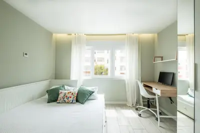 a small bedroom with a bed and a desk at Blue Star Luxury Apartment by Atlantic Places in Albufeira