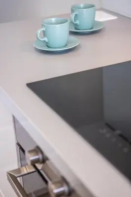 two coffee cups and a laptop on a counter at Blue Star Luxury Apartment by Atlantic Places in Albufeira