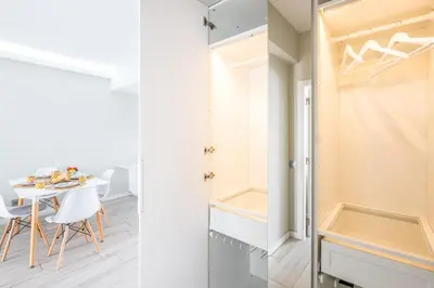 a kitchen and dining room with a table and a closet at Blue Star Luxury Apartment by Atlantic Places in Albufeira