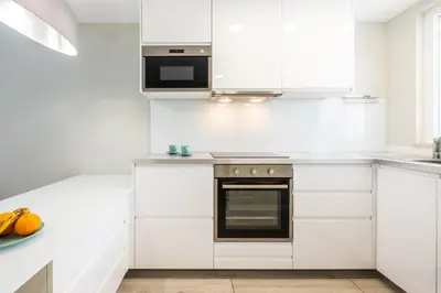 a white kitchen with white cabinets and a stove at Blue Star Luxury Apartment by Atlantic Places in Albufeira
