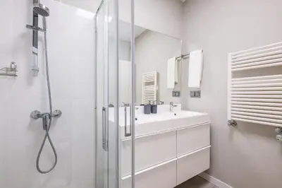 a white bathroom with a sink and a shower at Blue Star Luxury Apartment by Atlantic Places in Albufeira