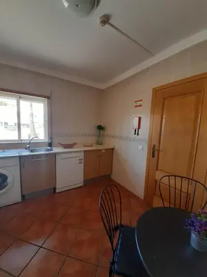 a kitchen with a table and a table and chairs at Flat Caballero in Guia