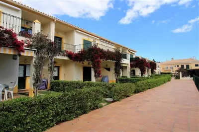a building with flowers on the side of a sidewalk at Vilamoura MiraGolf With Pool by Homing in Vilamoura