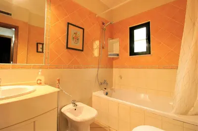 a bathroom with a sink and a toilet and a tub at Vilamoura MiraGolf With Pool by Homing in Vilamoura