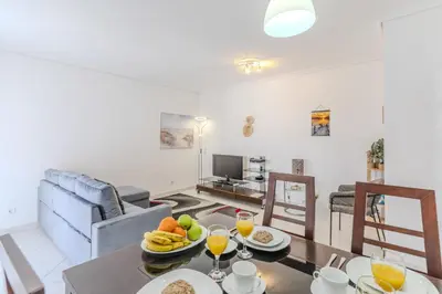 a dining room table with fruit and orange juice at #075 T1 Solar by Home Holidays in Albufeira