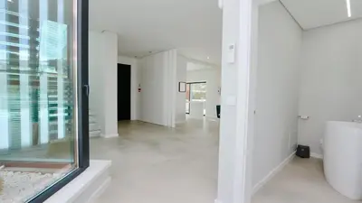 an open hallway with white walls and a glass window at Villa Waterfall - Clever Details, luxury, 5min walking from the center in Vilamoura