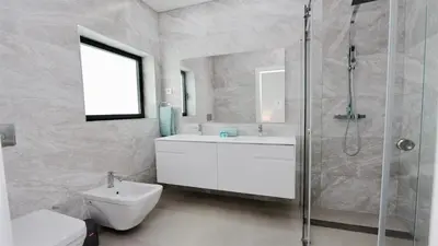 a bathroom with a shower and a sink and a toilet at Villa Waterfall - Clever Details, luxury, 5min walking from the center in Vilamoura
