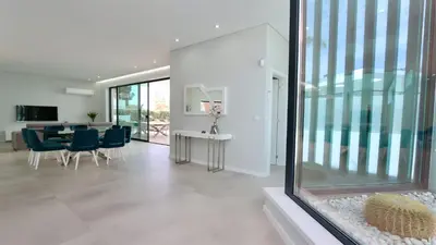 a living room with a table and blue chairs at Villa Waterfall - Clever Details, luxury, 5min walking from the center in Vilamoura